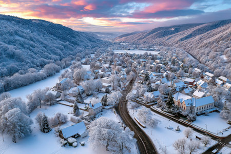 Aerial view of a snowcovered village in a valley at sunriseの写真素材