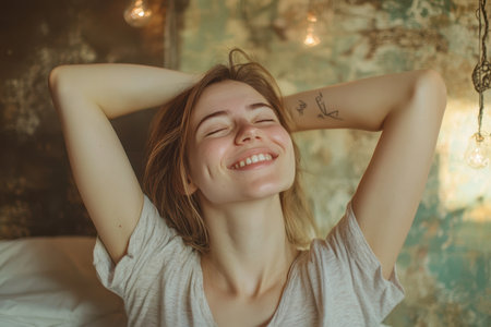 A young woman relaxes in a peaceful bedroom, smiling and enjoying her tranquil surroundings.の素材