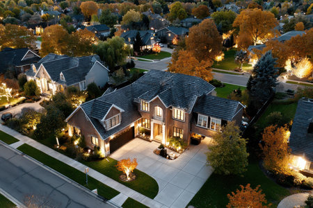 An aerial view of a suburban home at dusk during the autumn seasonの素材