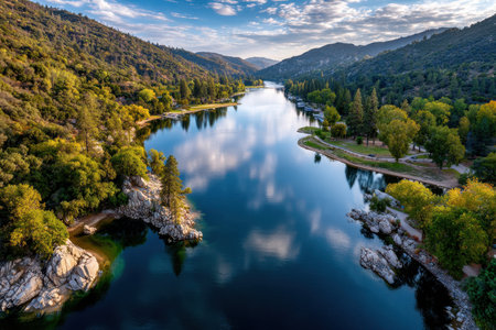 An aerial view of a serene lake nestled amidst mountains, with a vibrant sunset reflecting on the waterの素材