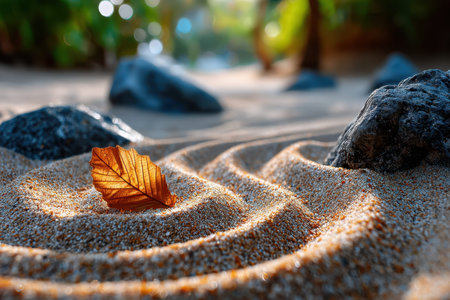 A tranquil shot of a zen garden with perfectly raked sand, embodying harmony and mindfulness, under soft, diffused sunlight, using a macro lens on a DSLR, where a single leaf has fallen on the sandの写真素材