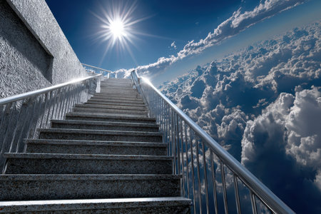 A staircase rises towards the clouds with radiant sunlight illuminating the scene, creating a surreal atmosphere.の写真素材
