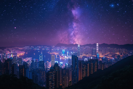 Skyscrapers illuminate the city as the Milky Way stretches high above Hong Kong at night.の素材