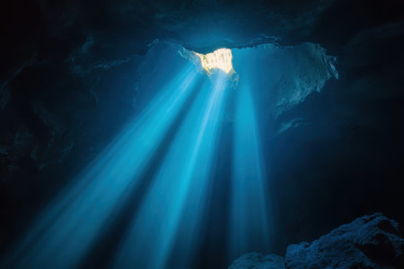 Stunning natural light filters down into an underwater cave, illuminating its mysterious depths and textures.の素材