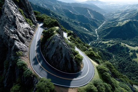 An aerial view of a winding road through a mountainous landscapeの写真素材