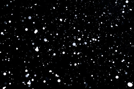 Falling snow on black background Snowflakes Flying in the air.の写真素材