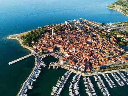 Aerial view of old town Izola in Slovenia, beautiful cityscape with marina at sunset. Adriatic sea...