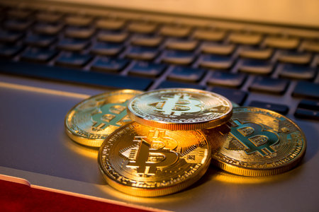 Photo Golden Bitcoins On laptop. Trading Concept Of Crypto Currency