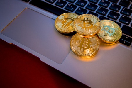Photo Golden Bitcoins On laptop. Trading Concept Of Crypto Currencyの写真素材