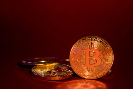 Photo Golden Bitcoins On Red Background. Trading Concept Of Crypto Currency