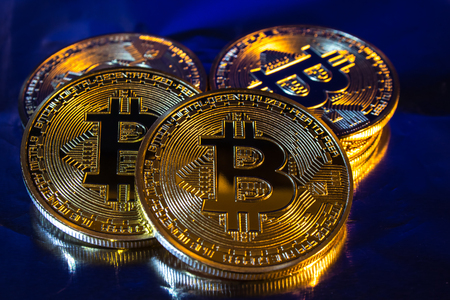 Photo of cryptocurrency physical golden bitcoin coin on colorful backgroundの写真素材