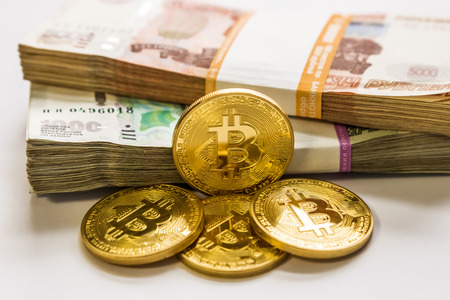 bitcoin gold and the Russian ruble. Bitcoin coin on the background of Russian rubles.の写真素材