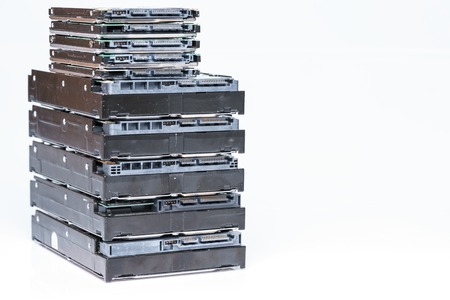 stack of old hard drives on white backgroundの写真素材