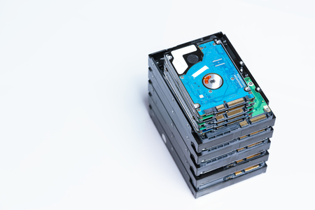 stack of old hard drives on white backgroundの写真素材