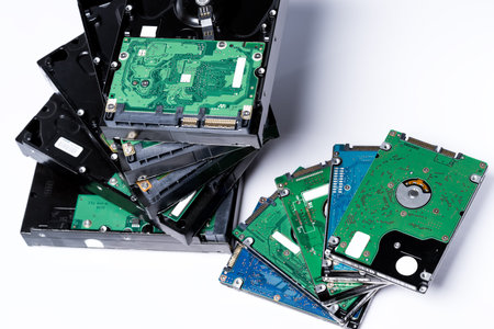 stack of old hard drives on white background
