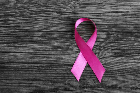 health symbol pink ribbon on wooden board background.の写真素材