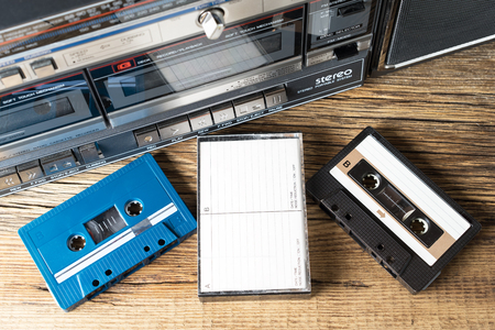 cassette tapes and recorder on old wooden surfaceの写真素材