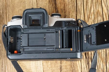 The back view of an old film camera wooden backgroundの写真素材