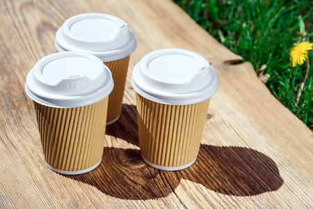 recycled paper coffee cup on wooden tableの写真素材