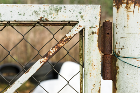old gate closeup rusty hinges wearing paintの写真素材