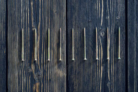 screws on old woodの写真素材