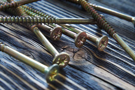 screws on old woodの写真素材