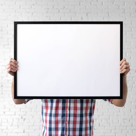 Holding frame mockup. Photo Mockup. The man hold frame. For frames and posters design.の写真素材