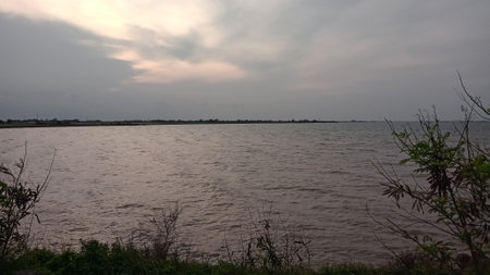 Beautiful view of the river and the cloudy sky in the eveningの写真素材