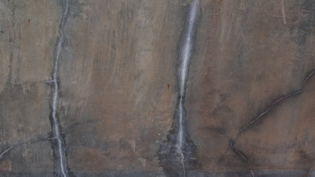 Old concrete wall with cracks and scratches. Abstract background for design.の写真素材