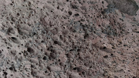 Close up of the surface of a rock with holes in it.の写真素材