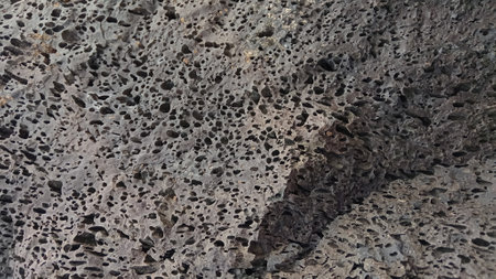 Texture of stone with holes in the form of a pattern. Natural backgroundの写真素材