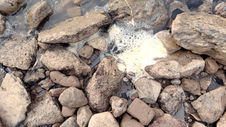 Pile of stones in the water. Abstract background and texture for design.の写真素材