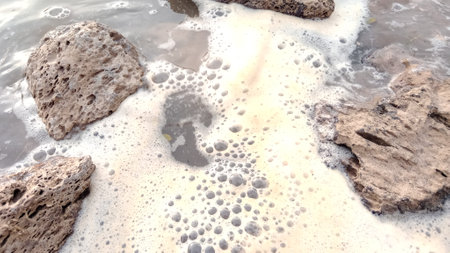 Beach and sea waves with foam and rocks. Sea waves on the beach.の写真素材