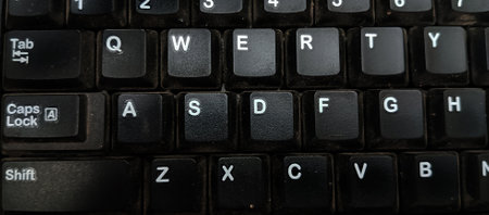 Close up of black computer keyboard with letters on it. Abstract backgroundの写真素材