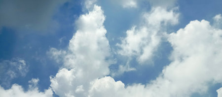 Blue sky and white clouds. Panoramic background for design.の写真素材