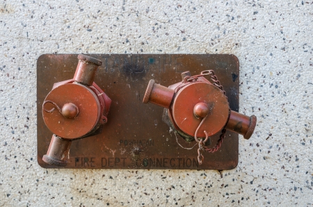 red color standpipe on wallの写真素材