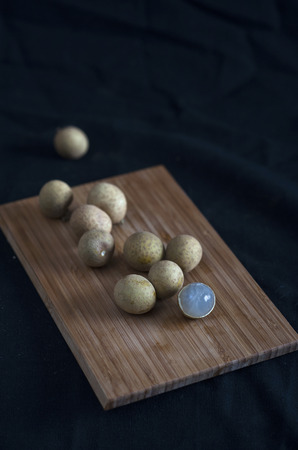 Longan fruit on a wooden boardの写真素材