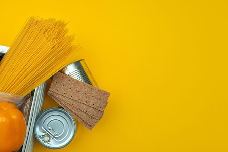Food donations on yellow backgroundの写真素材