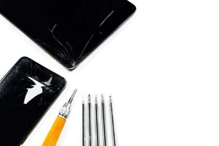 Smartphone repair concept. Broken tablet, mobile and repair toolsの写真素材