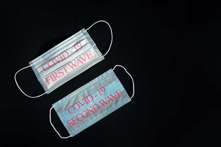 New and used medical masks isolated on a black background.の写真素材