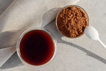 Closeup carob drink and carob in powder without caffeine. Natural tasty drinkの写真素材