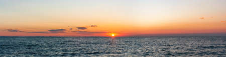 Beautiful sunrise over the sea. Panorama banner or print. Vacation holiday concept background wallpaper. Amazing panorama landscapeの写真素材