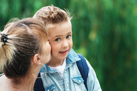 Mom kissing son before going to school