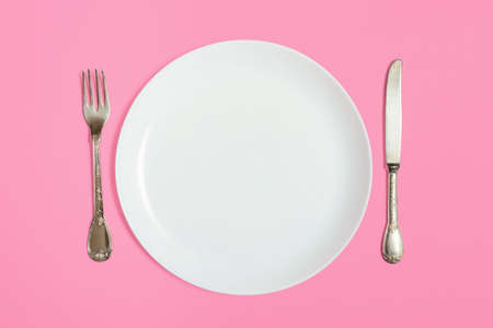 White empty plate with fork and knifeの写真素材