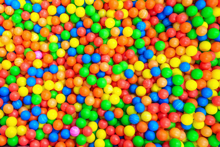 Multi-colored balls in a childrens attraction. Background texture of colourful foam balls