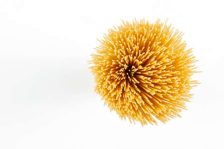 Top view of uncooked spaghetti isolated on whiteの写真素材