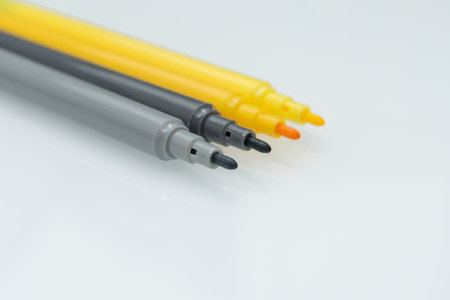 Gray and Yellow Felt-Tip Pens. Color of the Year 2021. Selective focus. Isolated on a white...