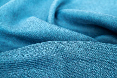 Blue fabric texture close up, focus only one point, soft blurred background wallpaper. Rough fabric texture, textile industry background with blurred. Colored cotton cloth. Abstract backgroundの写真素材