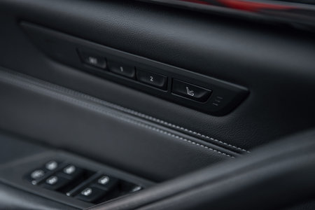 Car seat massage control panel. Massagers button. Close-up of the luxury car black interior