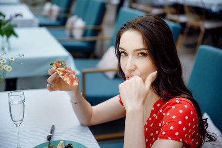 Young woman eating bruschetta. Sensual girl. Sexy beautiful model with bruschetta.の写真素材